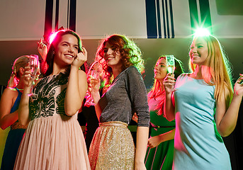 Image showing smiling friends with glasses of champagne in club