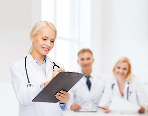 Image showing smiling female doctor with clipboard