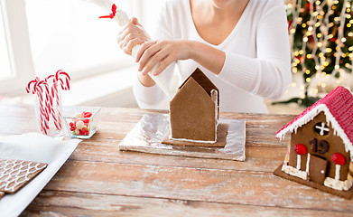 Image showing close up of woman making gingerbread houses