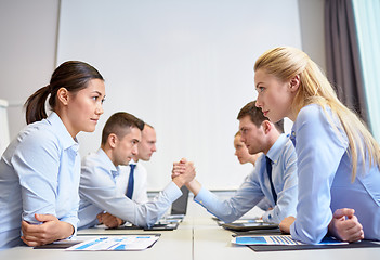 Image showing smiling business people having conflict in office