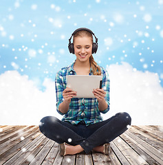 Image showing happy young woman with tablet pc and headphones