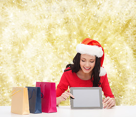 Image showing smiling woman with shopping bags and tablet pc