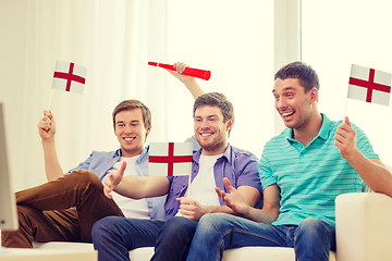 Image showing happy male friends with flags and vuvuzela