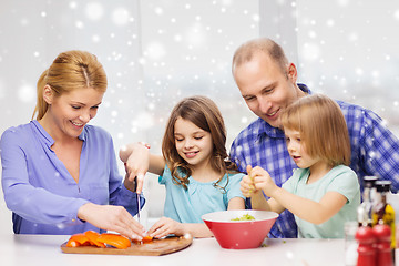 Image showing happy family with two kids making dinner at home