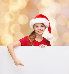 Image showing girl in santa helper hat with blank white board