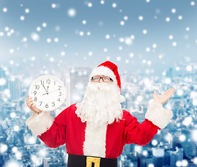 Image showing man in costume of santa claus with clock