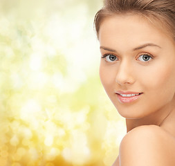 Image showing beautiful young woman over yellow background