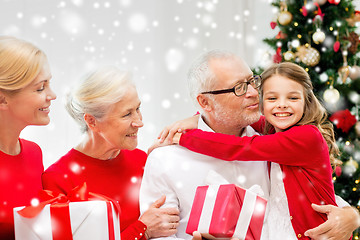 Image showing smiling family with gifts at home