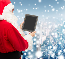 Image showing man in costume of santa claus with tablet pc