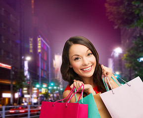 Image showing smiling young woman with shopping bags