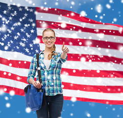 Image showing smiling girl in casual clothes showing thumbs up