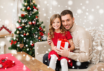 Image showing smiling father and daughter holding gift box