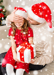 Image showing smiling father and daughter holding gift box