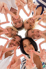 Image showing smiling friends in circle