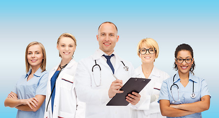 Image showing group of smiling doctors with clipboard