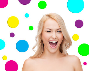 Image showing beautiful young woman over polka dot background