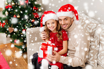 Image showing smiling father and daughter holding gift box