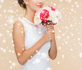 Image showing close up of woman in white dress with flowers