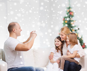 Image showing happy family with camera at home