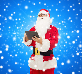 Image showing man in costume of santa claus with tablet pc