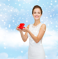 Image showing smiling woman holding red gift box