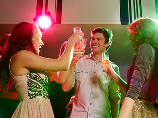 Image showing smiling friends with glasses of champagne in club