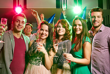 Image showing smiling friends with glasses of champagne in club