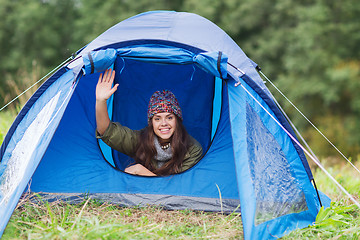 Image showing smiling female tourist in tent