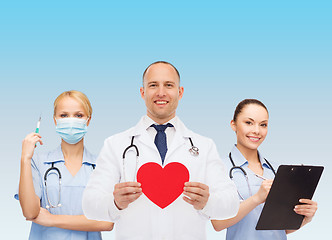 Image showing group of smiling doctors with red heart shape