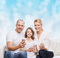 Image showing happy family with smartphones