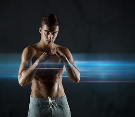 Image showing young man in fighting or boxing position