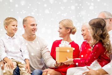 Image showing smiling family with gifts at home