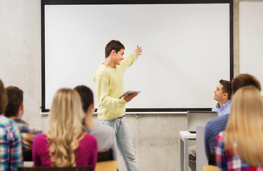 Image showing group of smiling students and teacher in classroom