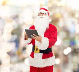 Image showing man in costume of santa claus with tablet pc