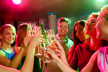 Image showing smiling friends with wine glasses and beer in club