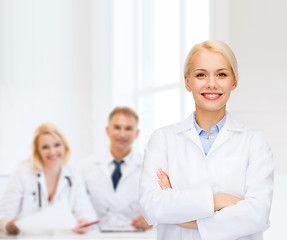 Image showing smiling female doctor with group of medics