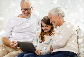 Image showing smiling family with tablet pc at home