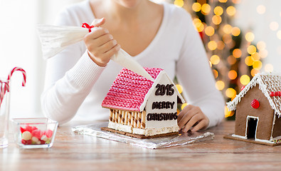 Image showing close up of woman making gingerbread houses