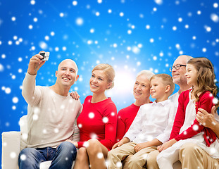 Image showing smiling family with camera