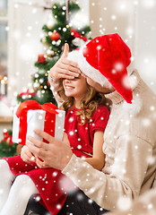 Image showing smiling father and daughter holding gift box