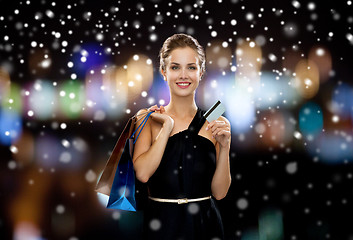 Image showing smiling woman with shopping bags and credit card