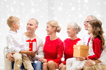 Image showing smiling family with gifts at home