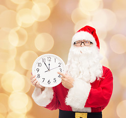 Image showing man in costume of santa claus with clock