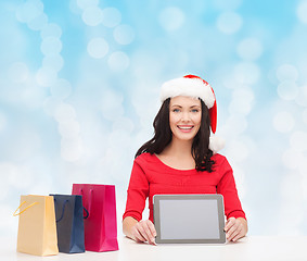 Image showing smiling woman with shopping bags and tablet pc