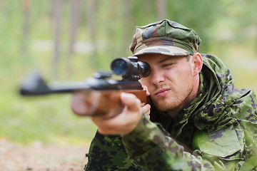 Image showing young soldier or hunter with gun in forest