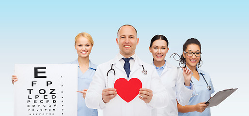 Image showing group of smiling doctors with red heart shape