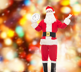 Image showing man in costume of santa claus with clock