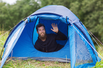 Image showing smiling male tourist with beard in tent