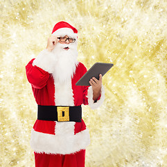 Image showing man in costume of santa claus with tablet pc