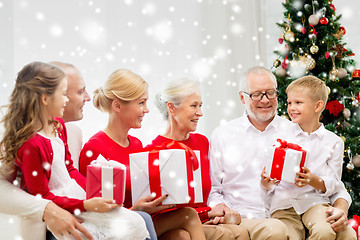 Image showing smiling family with gifts at home